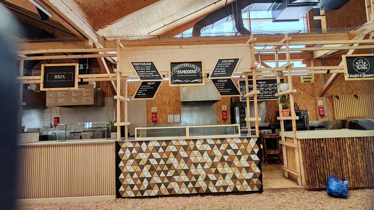Full Mediterranean Samoosas stall with menus and triangle counter at OZCF